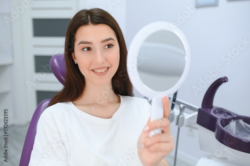 Young smiling woman with beautifiul teeth, having a dental inspection