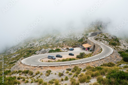 Mountain winding road washed in clouds.
