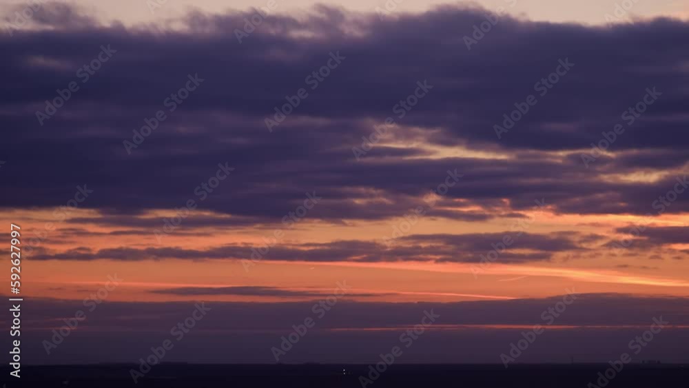 Evening clouds in the orange light of sunset rays, time lapse. Sunset sky with red light of the setting sun, timelapse Evening clouds in the orange light of sunset rays, time lapse. Sunset sky with red light of the setting sun, timelapse