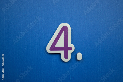 4. number of. Placed on a blue background, photographed from above.