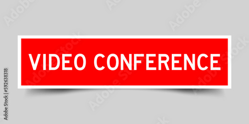 Red color square shape sticker label with word video conference on gray background