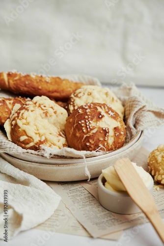Closeup of delicious Laugen buns with salt and butter on a white table