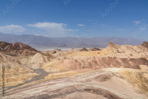 Scenic view of Badlands of Zabriskie Point  Furnace creek  Death Valley National Park  California  USA. Erosional landscape of multi hued Amargosa Chaos rock formations  Panamint Range in the back