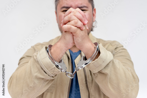 Obraz na plátně A man in handcuffs begs to be released