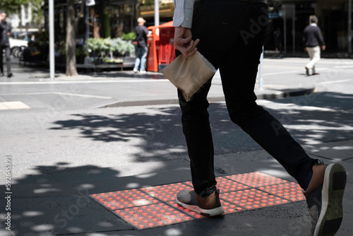 Pedestrian crossing lights embedded in the pavement for phone zombies that never look up at pedestrian crossings in Melbourne, Australia. Bright green square glowing tiles in action
