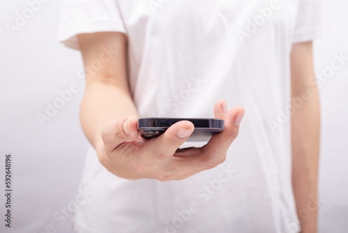 Female hand on smartphone shown above.