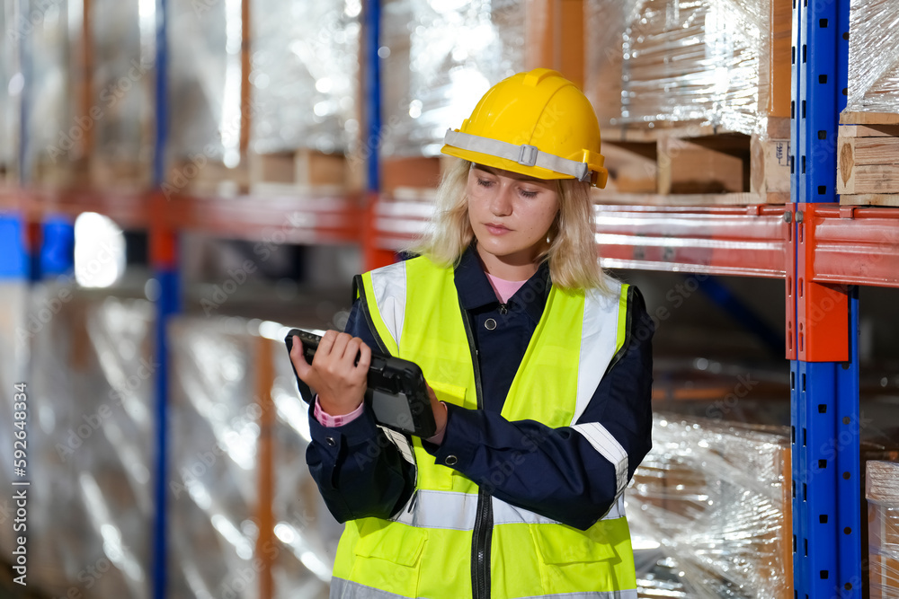 woman worker or supervisor controlling stock in a warehouse. woman worker or supervisor controlling stock in a warehouse.