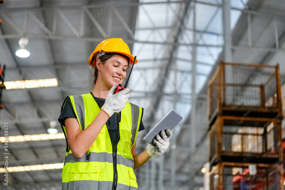 Multiethnic industrial workers checking their logistic lists while working with transportation of goods in warehouse Multiethnic industrial workers checking their logistic lists while working with transportation of goods in warehouse