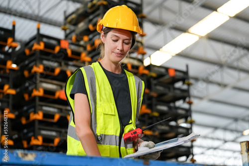 woman worker or supervisor controlling stock in a warehouse. © FotoArtist