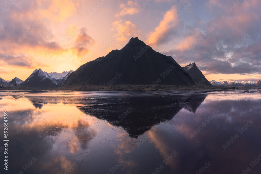 Drone view of mountains in sea during sunset Drone view of mountains in sea during sunset