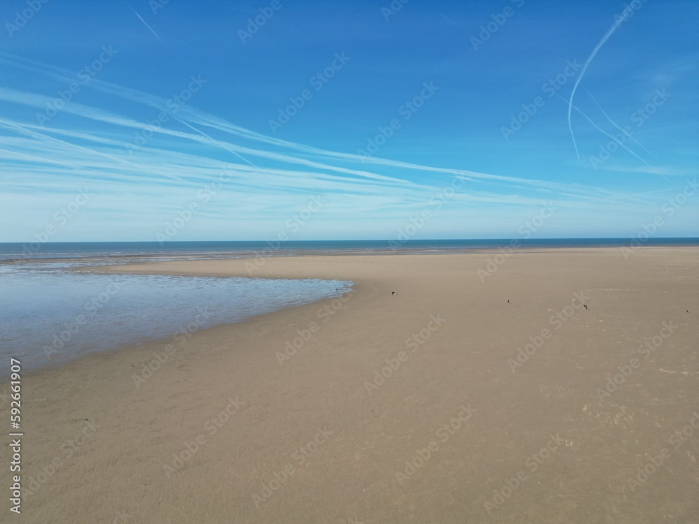 Aerial view of golden sand beach with low tide and blue sky background. Taken in Lytham Lancashire England. Aerial view of golden sand beach with low tide and blue sky background. Taken in Lytham Lancashire England.