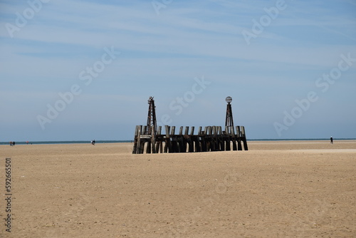 Old wooden pier On St Anne's beach in Lytham Lancashire England. Blue sky background and no people.  © ReayWorld