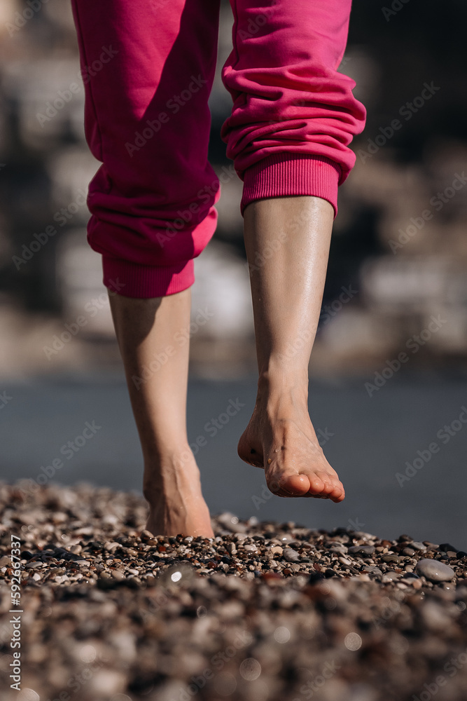 legs of a person walking on the beach legs of a person walking on the beach