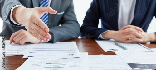 Panoramic of a businessman holding his hand in front in agreement next to a businesswoman