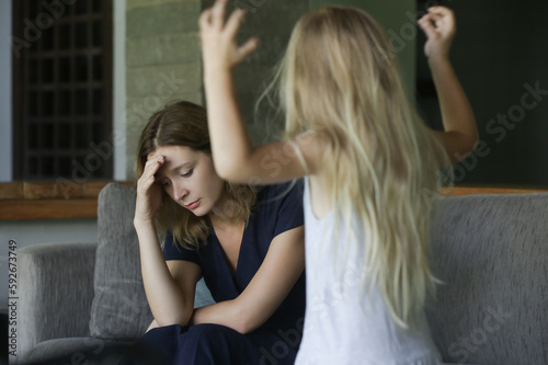 Tableau sur toile Family conflict - child throwing tantrum at tired mother