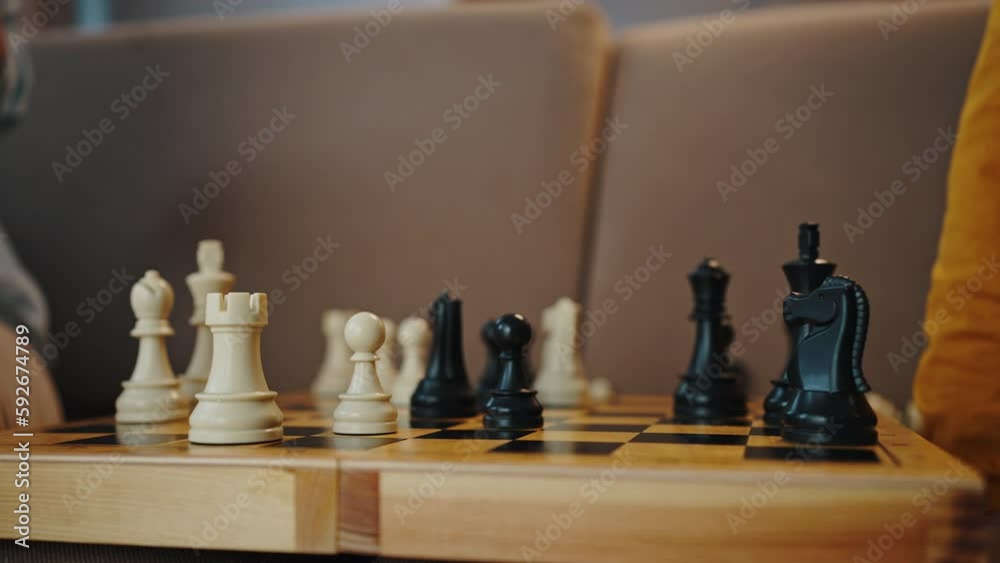 Close-up of the hands of a grandmother and child moving chess pawns on chessboard. Slow motion Close-up of the hands of a grandmother and child moving chess pawns on chessboard. Slow motion