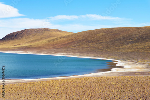 Amazing deep blue lagoon of Laguna Miniques, located in the altiplano of Antofagasta region, Los Flamencos national reserve,  Chile, South America photo