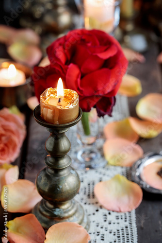 Romantic table decoration with roses and candles. Valentine s Day decorating ideas.