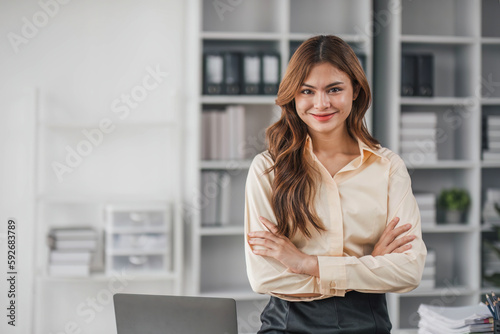 Business woman using calculator for do math finance on wooden desk in office and business working background, tax, accounting, statistics and analytic research concept..