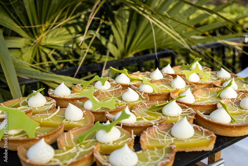 Keyline pastries in an outdoor buffet with a tropical setting.