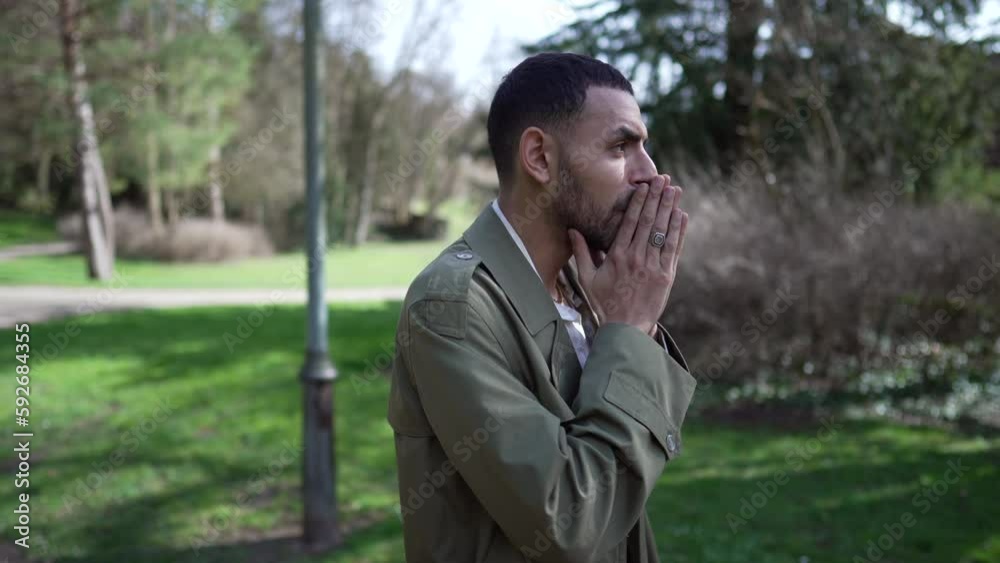 One worried Arab man standing outside with thoughtful expression. Preoccupied emotion of a Middle Eastern male person outdoors at park One worried Arab man standing outside with thoughtful expression. Preoccupied emotion of a Middle Eastern male person outdoors at park