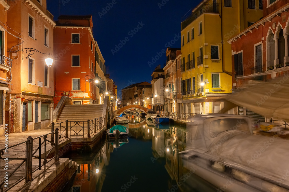 Typical Venetian canal with bridge at night, Venice, Italy