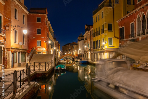 Typical Venetian canal with bridge at night, Venice, Italy