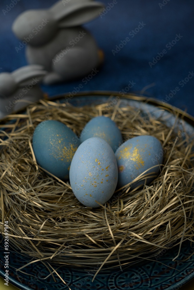 Closeup view of blue colored eggs on a plate decorated like a nest for the Easter celebration Closeup view of blue colored eggs on a plate decorated like a nest for the Easter celebration