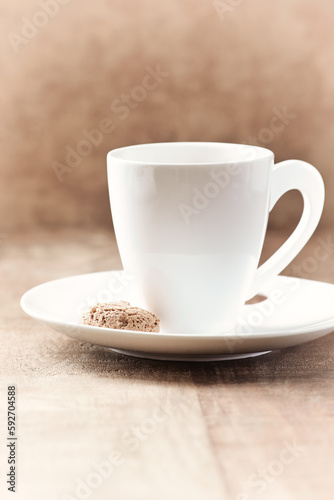 Amaretti (Italian biscuit) and a cup of coffee on wooden background. Close up. Copy space. 