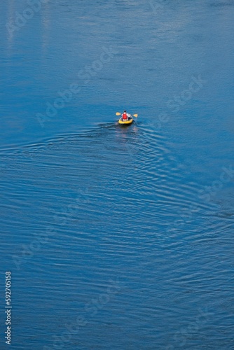 Man kayaking in River Axe in East Devon, UK