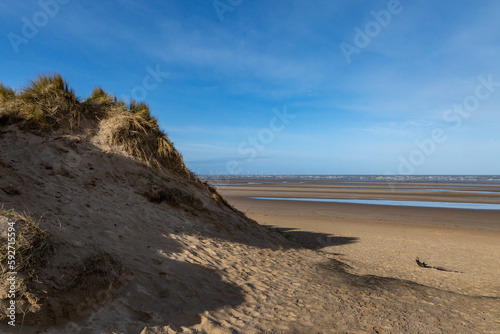 Blue sky over the sand dunes and vast sandy beach at Formby, in Merseyside