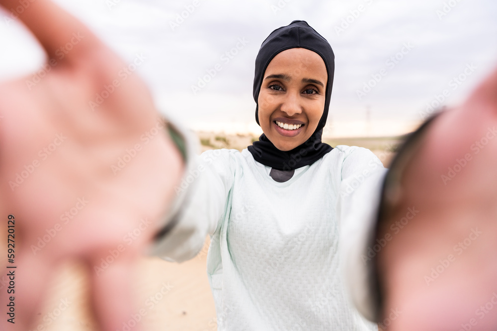 Beautiful middle-eastern arab woman wearing hijab training outdoors in a desert area - Sportive athletic muslim adult female wearing burkini sportswear doing fitness workout Beautiful middle-eastern arab woman wearing hijab training outdoors in a desert area - Sportive athletic muslim adult female wearing burkini sportswear doing fitness workout