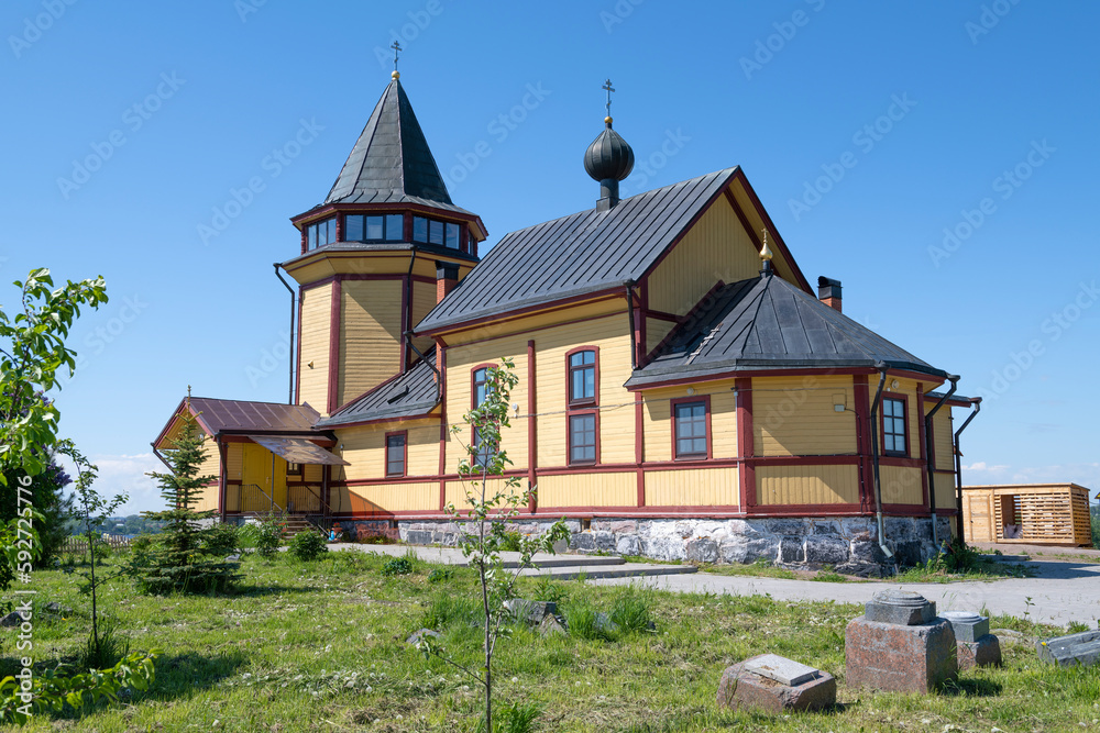 Ancient wooden church of St. Nicholas the Wonderworker on Riekkalansaari on a sunny June day. Sortavala. Republic of Karelia, Russia