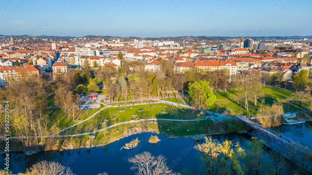 People chilling in the Augarten park in the city of Graz at the river Mur and enjoying the evening sun..