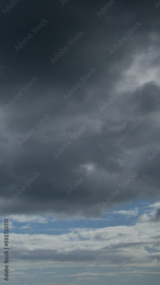 Time lapse video shows the white clouds racing in the blue sky. This footage is ideal for creating a background for your projects. Vertical video. Time lapse video shows the white clouds racing in the blue sky. This footage is ideal for creating a background for your projects. Vertical video.