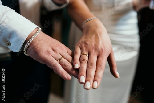 Closeup shot of the bride and groom hands with wedding rings