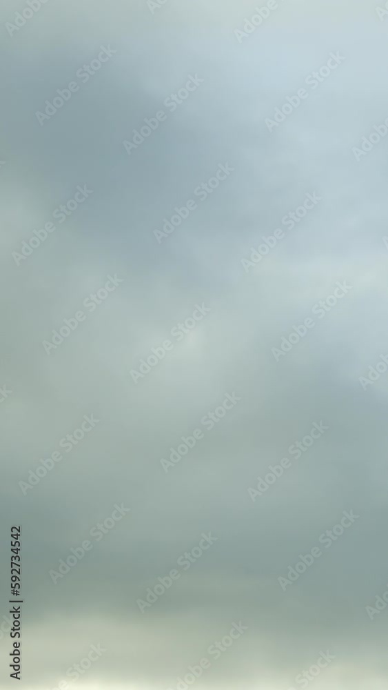 The sky is filled with a clouds, gently shifting and changing throughout the course of the timelapse. Vertical video. The sky is filled with a clouds, gently shifting and changing throughout the course of the timelapse. Vertical video.