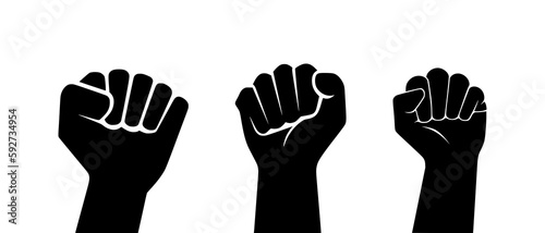 Fotografia Clenched fists raised in protest human hands in the air silhouette black filled