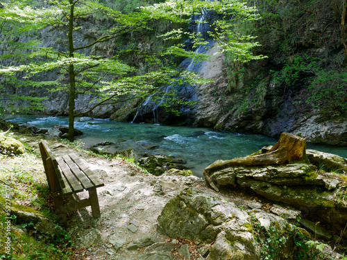Bench on a hiking trail next to a stream in the mountains    tscher region 