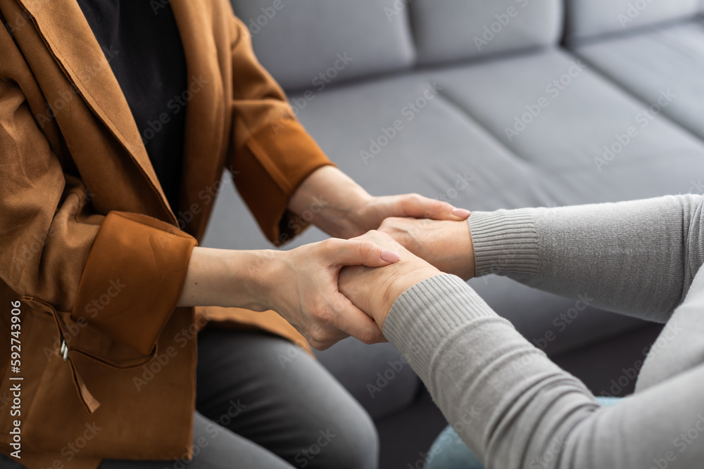 Closeup of a support hands. Closeup shot of a young woman holding a senior woman's hands in comfort. Female carer holding hands of senior woman