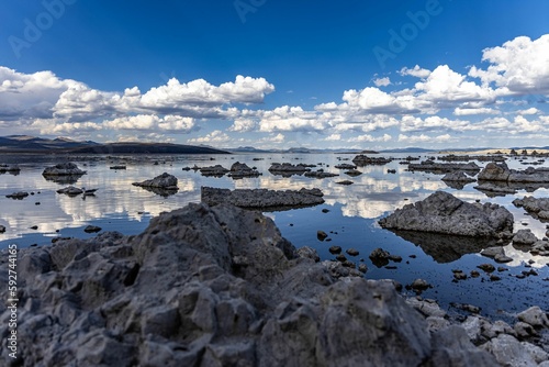 Scenic view of small rock formations in Mono Lake under a blue cloudy sky in California, USA