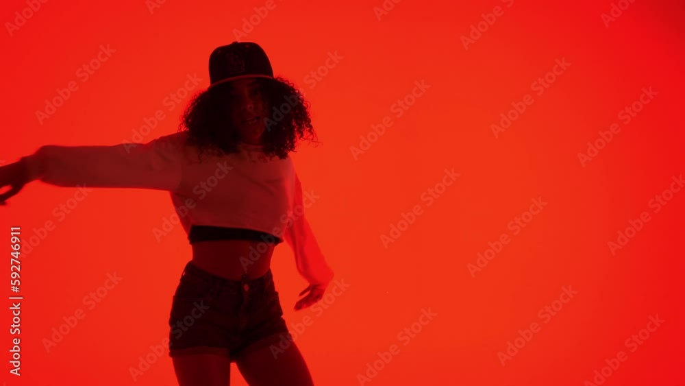 Fashion woman dancing in RnB style. The black young model moves ...