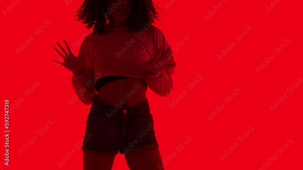 Fashion woman dancing in RnB style. The black young model moves ...