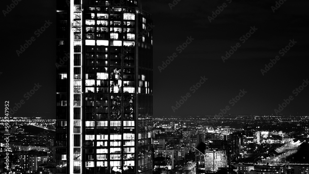 View of at night glass buildings and modern business skyscrapers,. View of modern skyscrapers and  business buildings in downtown. Big city at night. Black and white.