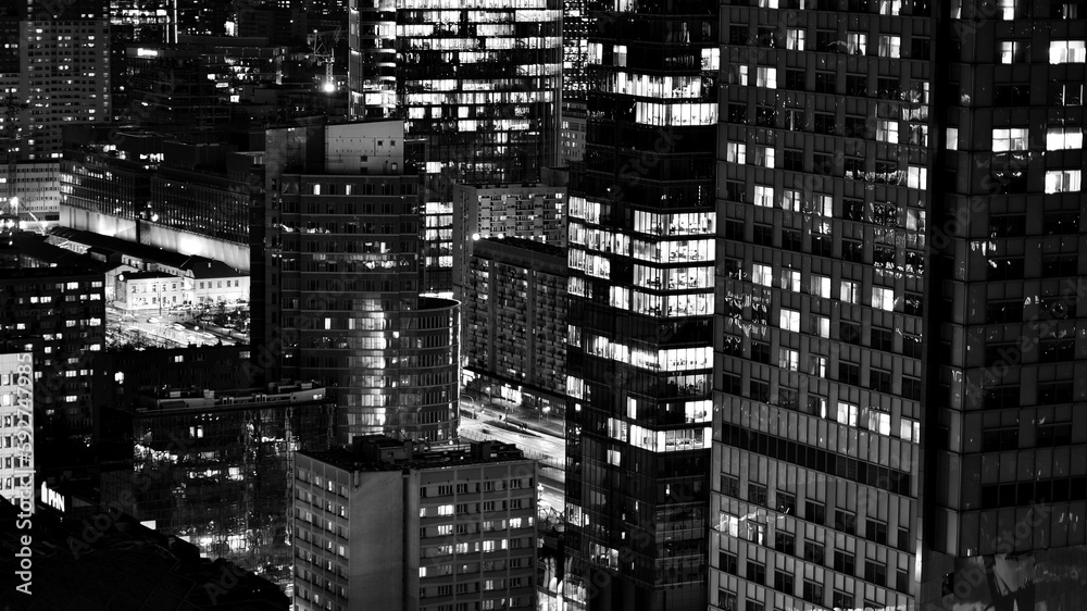 View of at night glass buildings and modern business skyscrapers,. View of modern skyscrapers and business buildings in downtown. Big city at night. Black and white. View of at night glass buildings and modern business skyscrapers,. View of modern skyscrapers and business buildings in downtown. Big city at night. Black and white.