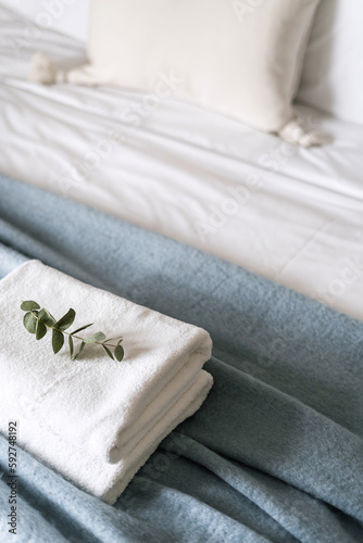 Fototapeta Naklejka Na Ścianę i Meble -  clean folded bath towels on bed in hotel room, closeup