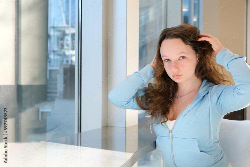 beautiful girl at the table in office straightens hair private school study to be beautiful excellent student perfect tender beauty of adolescence white face blue clothes puffy hair European Ukrainian beautiful girl at the table in office straightens hair private school study to be beautiful excellent student perfect tender beauty of adolescence white face blue clothes puffy hair European Ukrainian