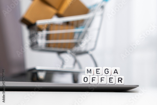 Payment methods words on cubes with a toy shopping cart and cardboard boxes in the background. Online shopping concept. 