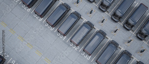 Fotografering Overhead high angle drone shot of fleet modern electric EV delivery vans standin