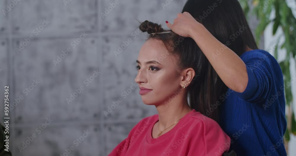 behind the scenes while preparing models for the camera shoot in a professional photo studio. An Asian stylist and a European make-up artist color the models and do their hair. behind the scenes while preparing models for the camera shoot in a professional photo studio. An Asian stylist and a European make-up artist color the models and do their hair.